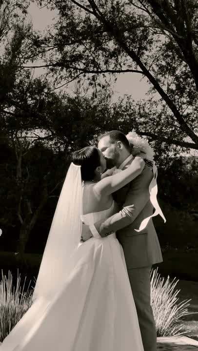 Black and white embrace between newlyweds